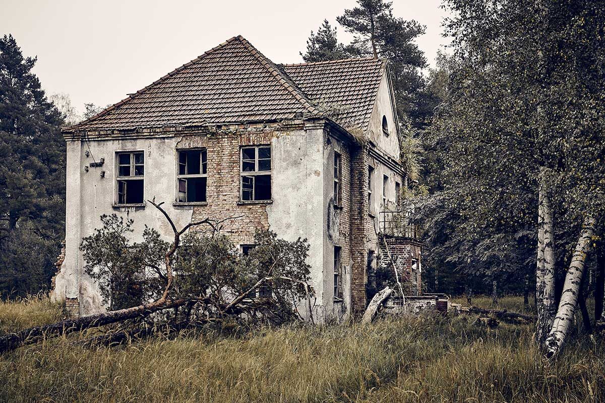 old-abandoned-house-on-a-grassy-field-surrounded-b-2023-11-27-05-13-55-utc