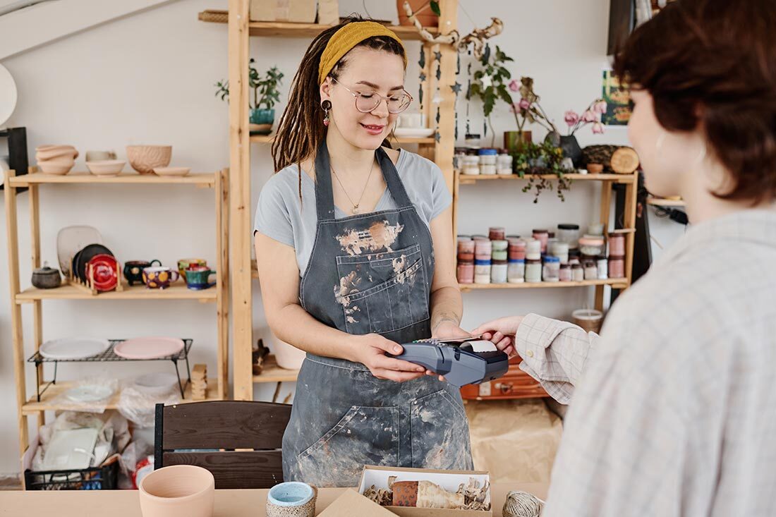 young-female-owner-of-small-earthenware-shop-selli-2025-03-13-10-34-22-utc