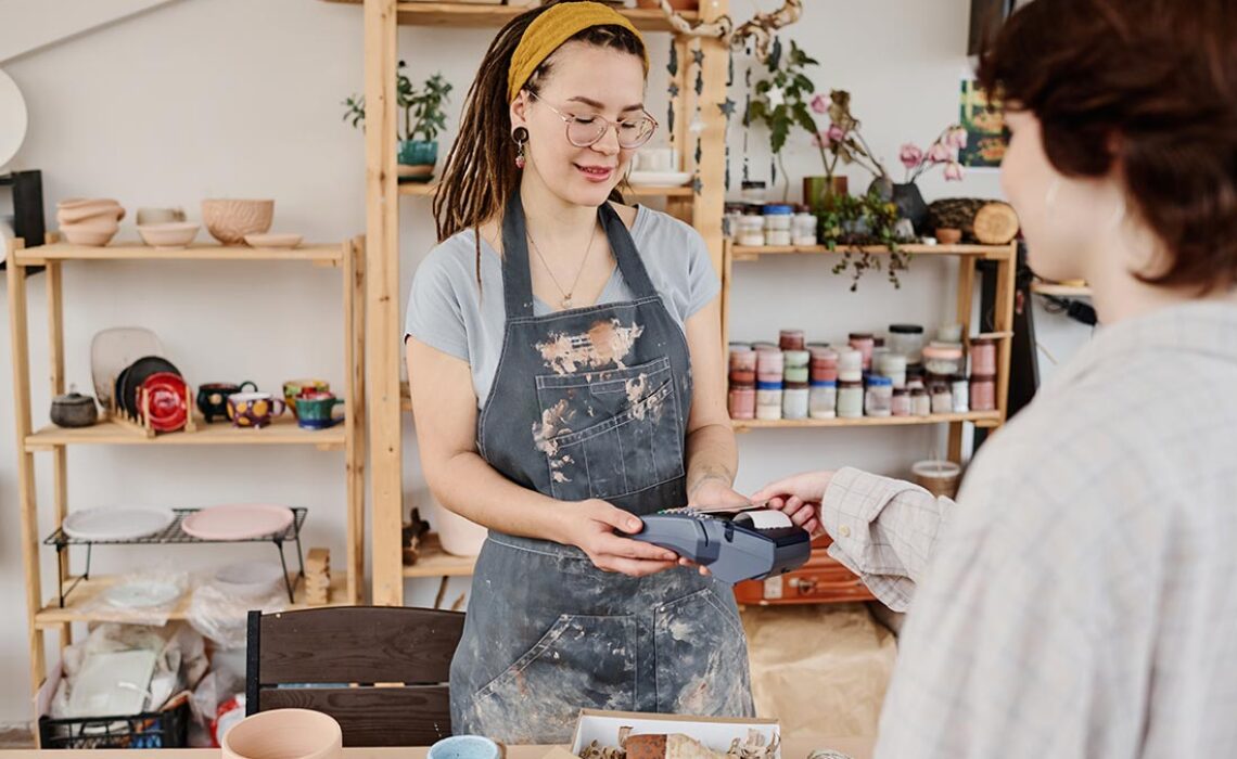 young-female-owner-of-small-earthenware-shop-selli-2025-03-13-10-34-22-utc